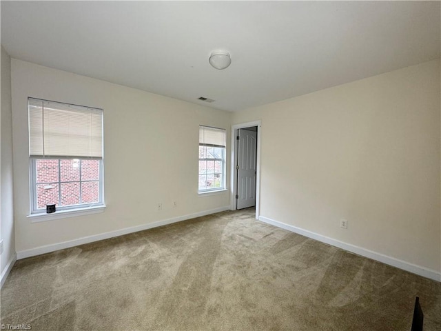 unfurnished room featuring light colored carpet