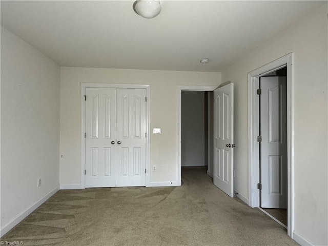 unfurnished bedroom featuring carpet flooring and a closet