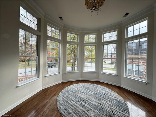 sunroom / solarium featuring a chandelier