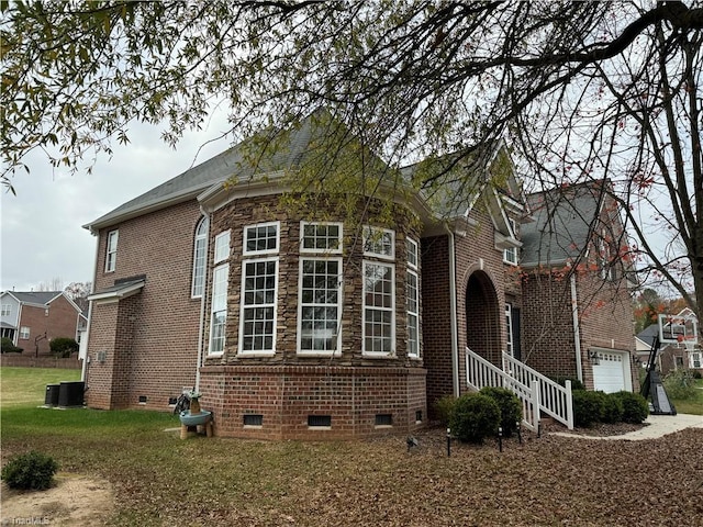 view of side of property featuring a garage and central air condition unit