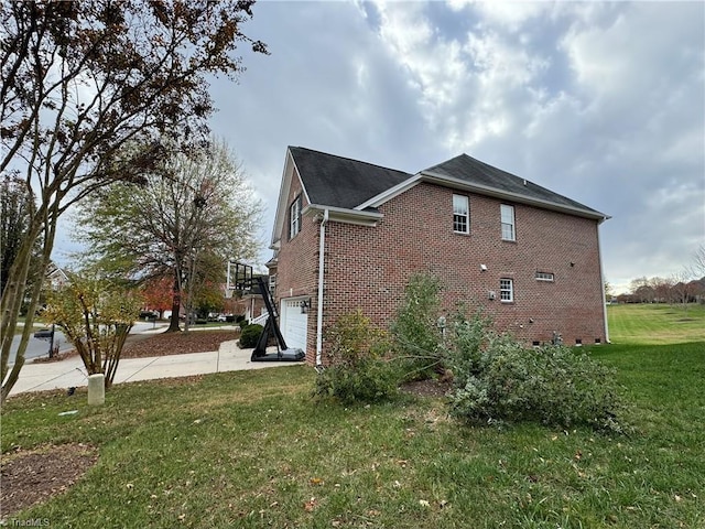 view of home's exterior with a yard and a garage