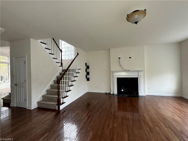 unfurnished living room featuring dark hardwood / wood-style flooring