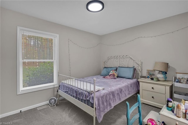 carpeted bedroom with multiple windows