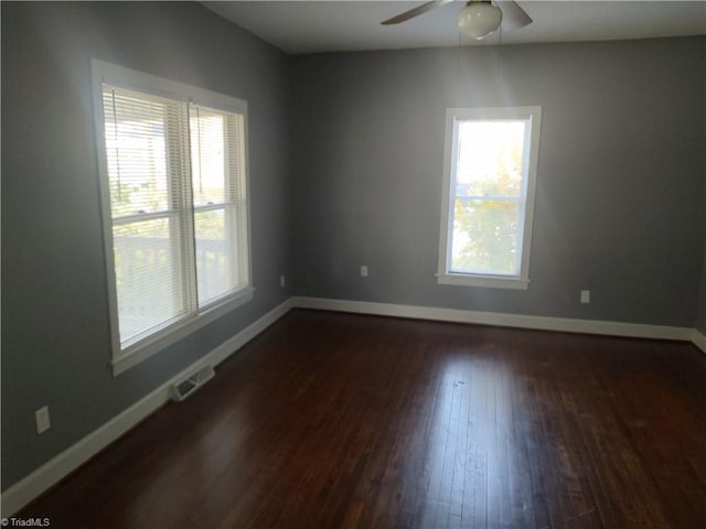 empty room featuring ceiling fan and dark hardwood / wood-style flooring