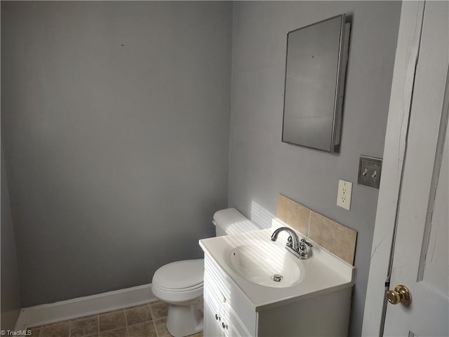 bathroom featuring tile patterned flooring, vanity, and toilet