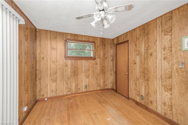 1788 Joshie Dr, Winston-Salem, NC 27103 - empty room with baseboards, wood finished floors, wooden walls, and a ceiling fan