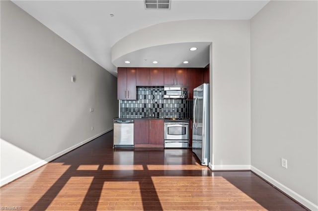 kitchen featuring tasteful backsplash, stainless steel appliances, and dark hardwood / wood-style floors