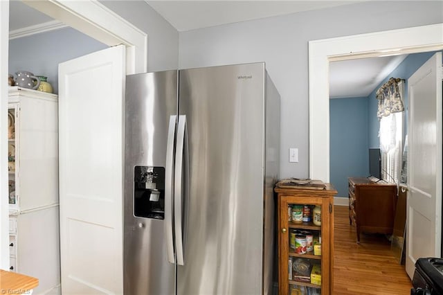 kitchen with black gas stove, wood finished floors, and stainless steel fridge with ice dispenser