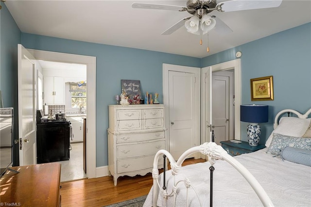 bedroom with a ceiling fan and wood finished floors