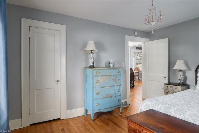 bedroom featuring baseboards and wood finished floors