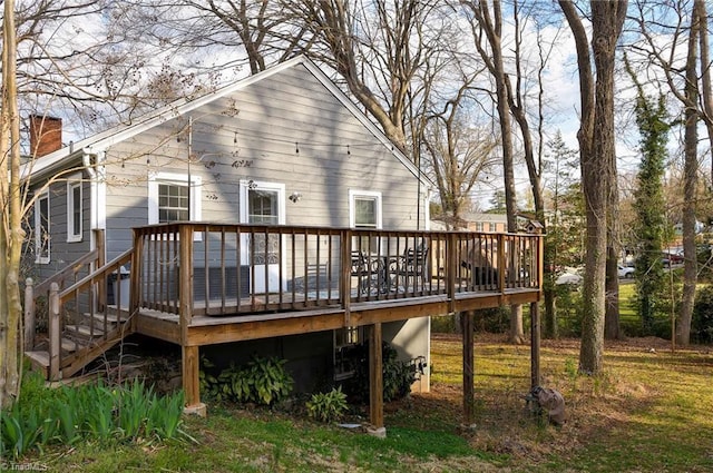 rear view of house with a wooden deck and a chimney