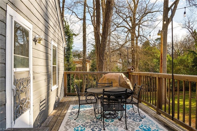wooden terrace with outdoor dining space