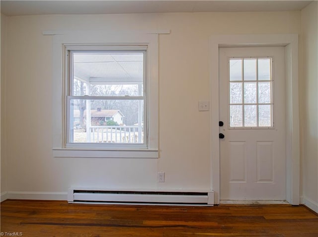 doorway to outside featuring a wealth of natural light, a baseboard radiator, baseboards, and wood finished floors