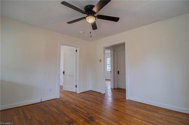 spare room with a ceiling fan, baseboards, a textured ceiling, and hardwood / wood-style floors