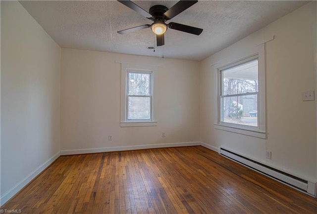 unfurnished room featuring a textured ceiling, ceiling fan, a baseboard radiator, baseboards, and hardwood / wood-style floors