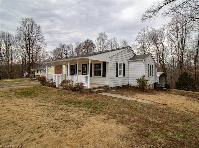 ranch-style house featuring a porch and a front yard