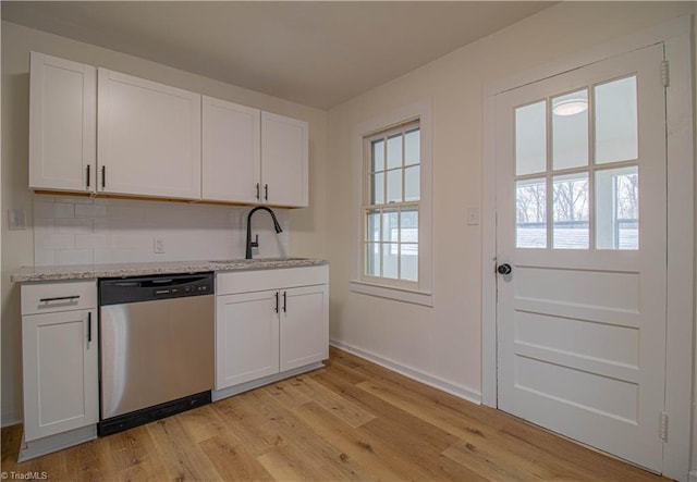 kitchen featuring light wood-style floors, white cabinetry, dishwasher, and a sink