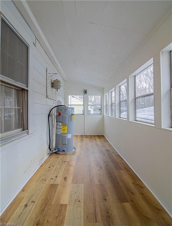 unfurnished sunroom featuring water heater