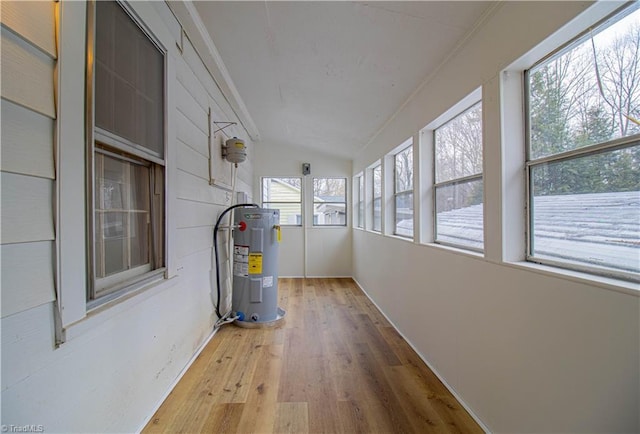 unfurnished sunroom with vaulted ceiling and electric water heater