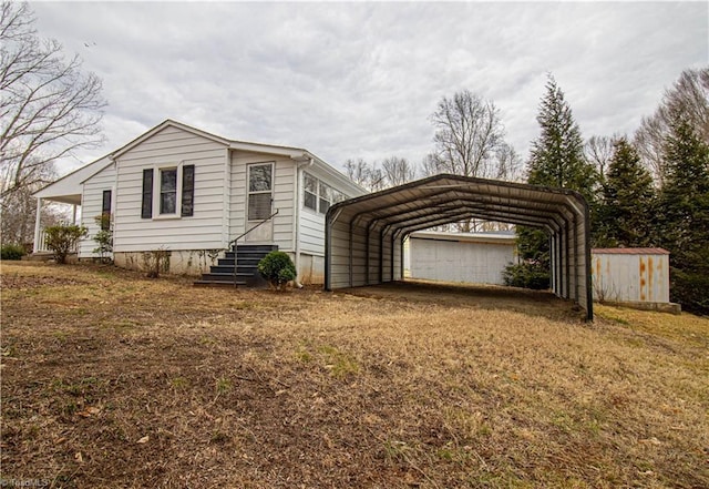 view of property exterior featuring driveway, entry steps, and a detached carport