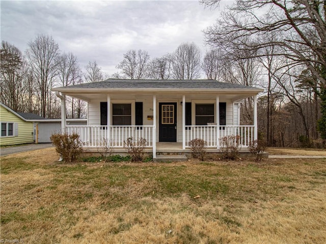 view of front of house featuring covered porch and a front lawn