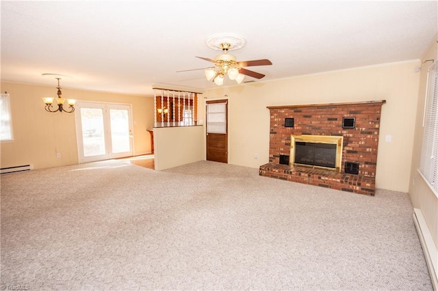 unfurnished living room featuring ceiling fan with notable chandelier, carpet flooring, a baseboard heating unit, crown molding, and a brick fireplace