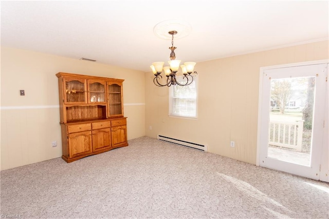 carpeted spare room featuring baseboard heating and an inviting chandelier