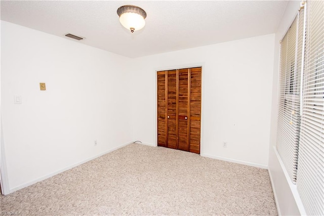 unfurnished bedroom featuring carpet floors and a closet