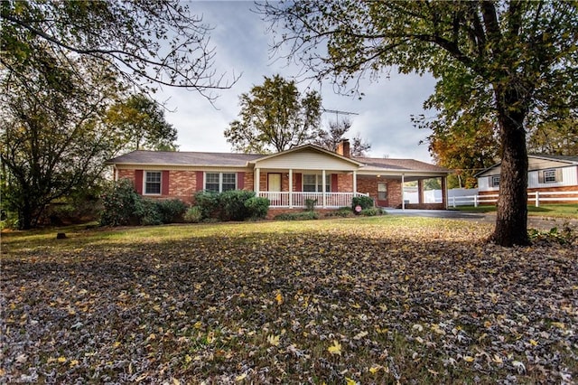 single story home featuring a carport and covered porch