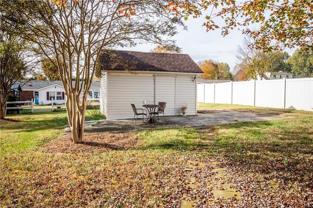 view of yard with a storage shed and a patio area