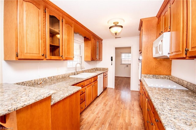 kitchen featuring white appliances, light stone countertops, sink, and light hardwood / wood-style flooring