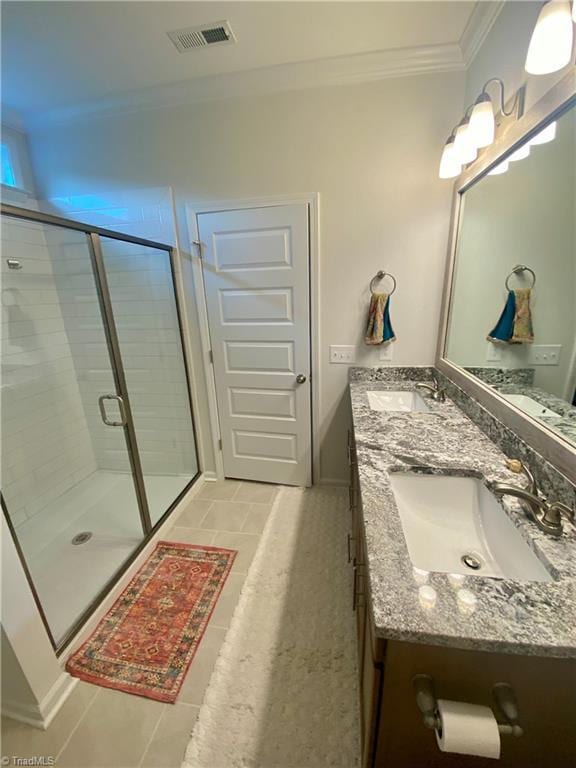 bathroom featuring walk in shower, vanity, tile patterned flooring, and ornamental molding