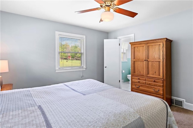 bedroom featuring visible vents, a ceiling fan, light carpet, and connected bathroom