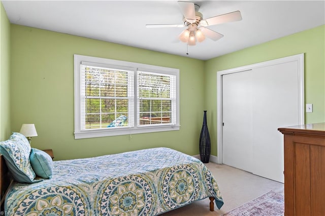 bedroom featuring carpet floors, a closet, a ceiling fan, and baseboards