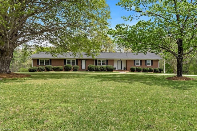 single story home with brick siding and a front yard