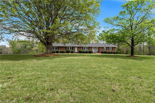 ranch-style home featuring a front yard
