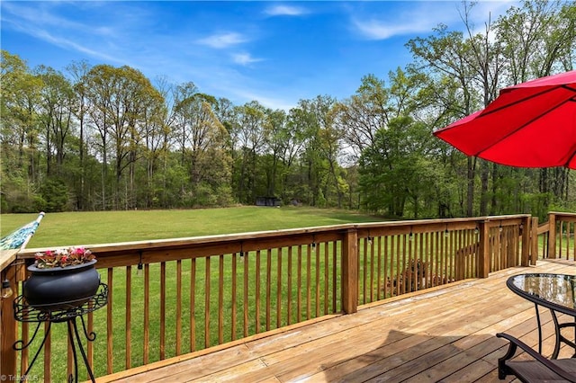 wooden terrace featuring a lawn