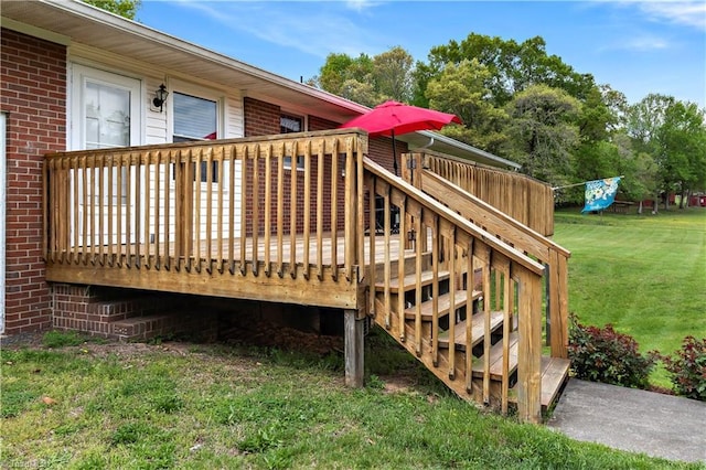 wooden deck featuring a yard and stairs