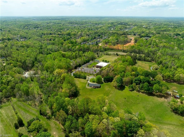 drone / aerial view featuring a wooded view