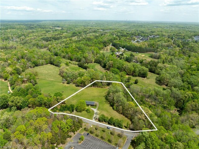 birds eye view of property with a view of trees