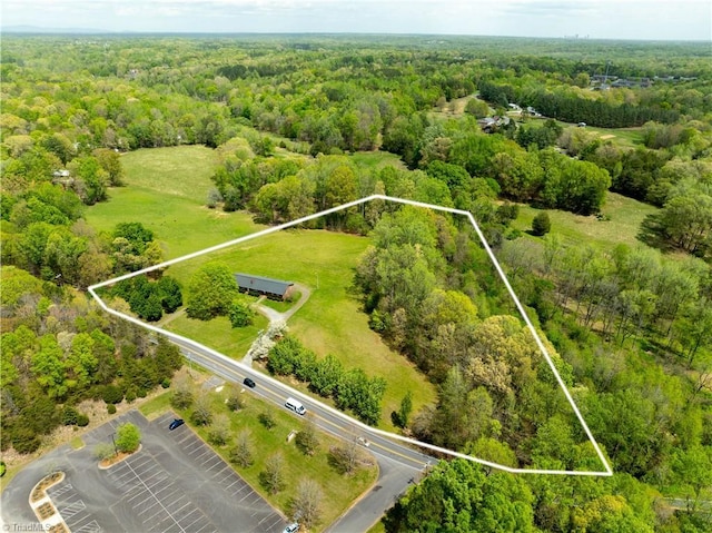 aerial view featuring a wooded view