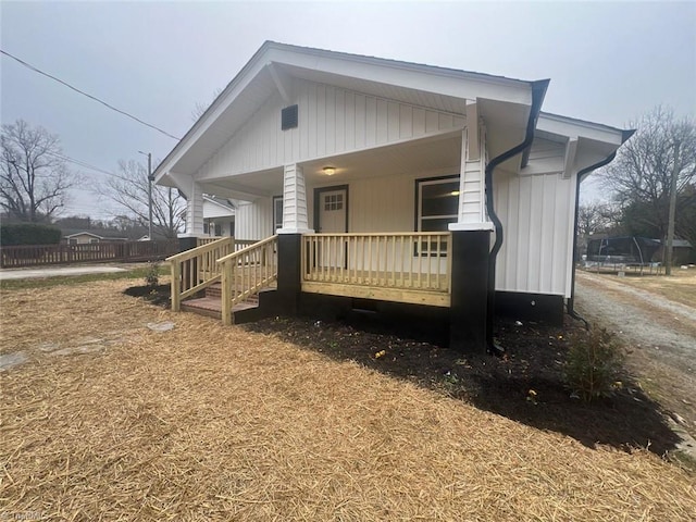 view of front facade with covered porch and a trampoline