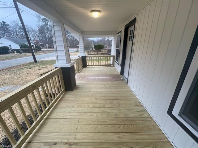 wooden terrace featuring covered porch