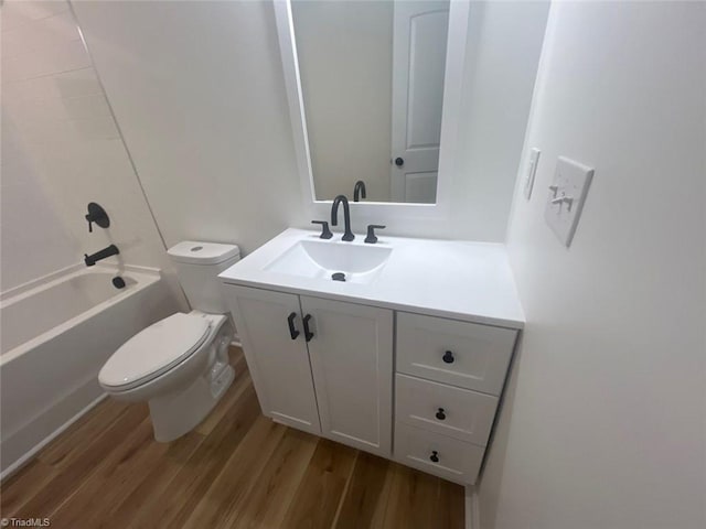 full bathroom featuring hardwood / wood-style floors, vanity, tub / shower combination, and toilet