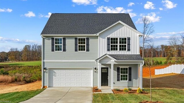 view of front of property featuring a front lawn and a garage