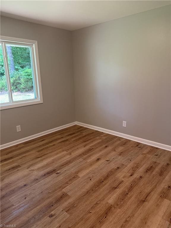 4115 Rose Lake Dr, Greensboro, NC 27407 - unfurnished room with baseboards and wood finished floors