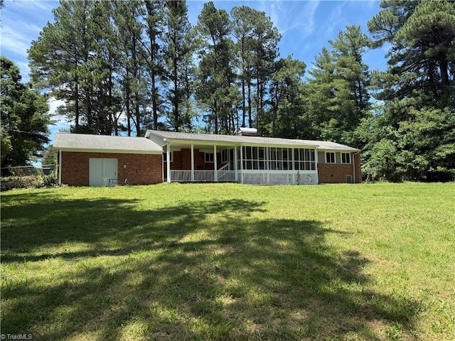 4115 Rose Lake Dr, Greensboro, NC 27407 - back of property with brick siding, a lawn, a chimney, and covered porch