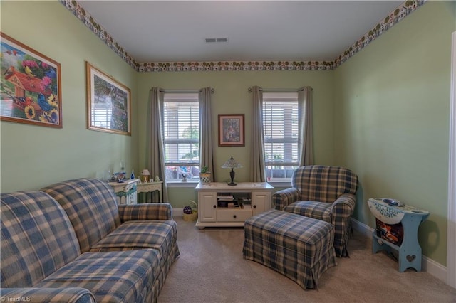 living area featuring carpet floors, a wealth of natural light, and baseboards