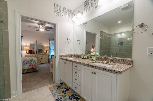 ensuite bathroom featuring double vanity, ensuite bath, a sink, and a shower stall