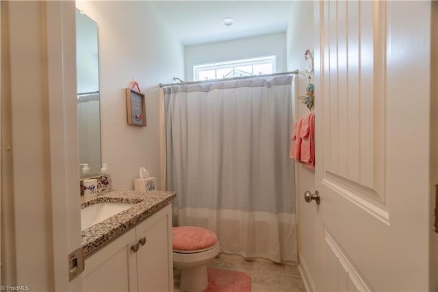 bathroom with toilet, vanity, and a shower with curtain